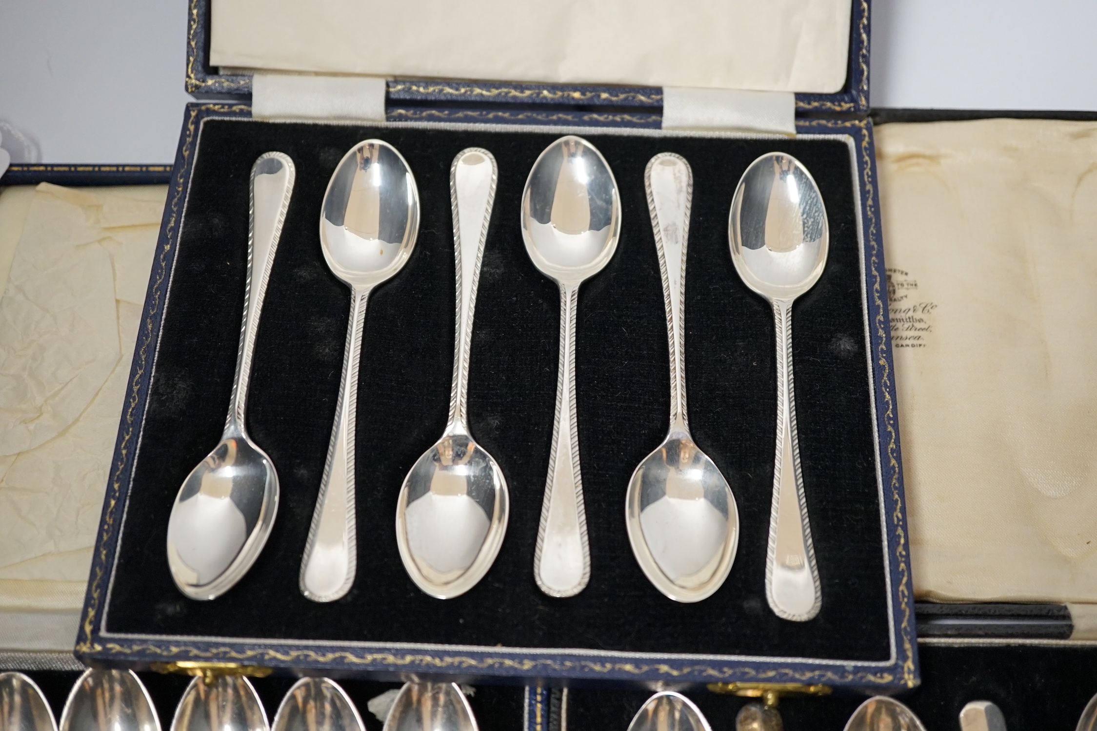 Three assorted cased sets of six silver tea or coffee spoons including Old English feather edge pattern.